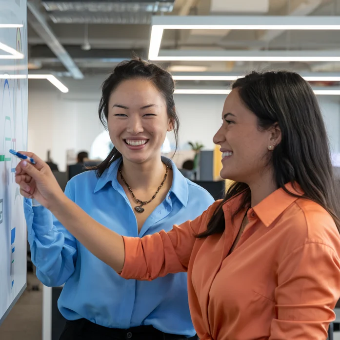 Two professionals collaborating at a planning board